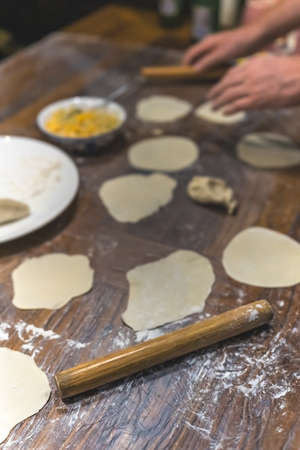 Wooden rolling pin which will be used for the making of traditional chinese dumplings during cooking...
