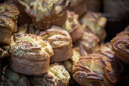 Large plate with delicious small sweet buns and cakes on sale in bakery in China