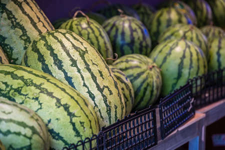 Huge watermelons for sale in a fruit and vegetable shop on the street in Zigong, Chinaの写真素材