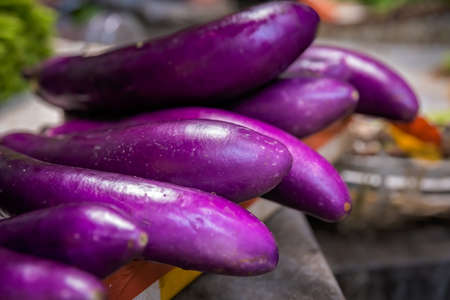 Pile ripe purple aubergines on sale on a street farmers market in Chinaの写真素材