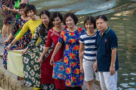 Feng Huang, China - August 2019 : Chinese Family and friends taking group photo on the riverbanks of Tuo riverのeditorial素材