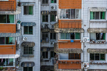 Zigong, China - July 2019 : Rooftops, windows and balconies of old residential buildings, blocks of...