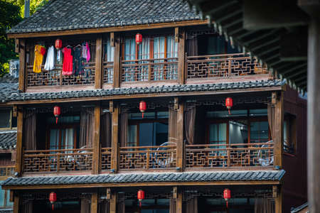 Feng Huang, China -  August 2019 : Facade of an old historic wooden Diaojiao house on the riverbanks of Tuo river, flowing through the centre of Fenghuang Old Townのeditorial素材