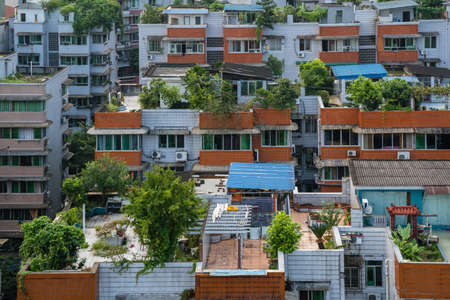 Zigong, China - July 2019 : Rooftops, windows and balconies of old residential buildings, blocks of...