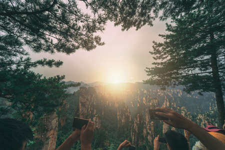 Zhangjiajie, China - August 2019 : Tourists taking pictures on mobile phones on the viewpoint in Tianzi mountain range, Avatar mountains nature parkのeditorial素材