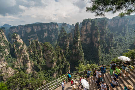 Zhangjiajie, China - August 2019 : Tourists taking pictures on mobile phones on the  Enchanting terrace viewpoint, Avatar mountains nature parkのeditorial素材