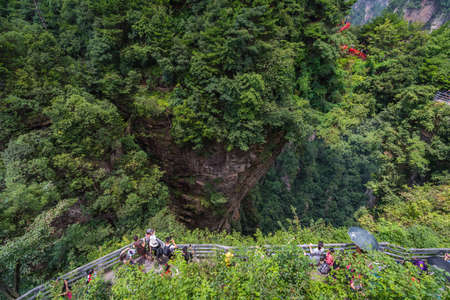 Zhangjiajie, China - August 2019 : Tourists taking pictures on mobile phones on the viewpoint of the Greatest Natural Bridge also known as Tian Qiao Sky Bridge, Avatar mountains nature parkのeditorial素材