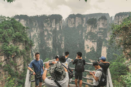 Zhangjiajie, China - August 2019 : Tourists taking pictures on mobile phones on the viewpoint in Tianzi mountain range, Avatar mountains nature parkのeditorial素材