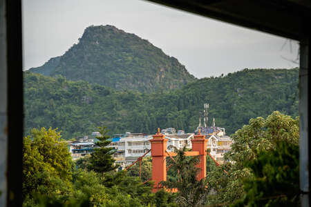 Red bridge on Sanduo Lu street in Guilin town city with karst mountains in the background, Guangxi Province, Chinaの写真素材