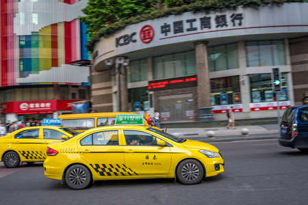 Chongqing, China - August 2019 : Yellow taxi driving on the busy and congested street