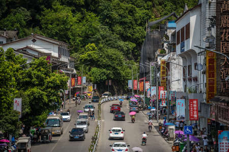 Yangshuo, China - August 2019 : Cars and traffic on the busy road lane in the centre of, Guangxi Provinceのeditorial素材