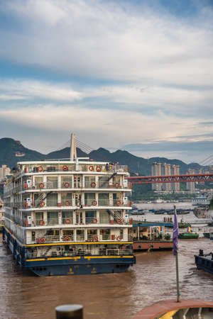Chongqing, China - August 2019 : Back of the luxury cruising ship docked in port on the riverbank of Yangtze river in Chongqing townのeditorial素材