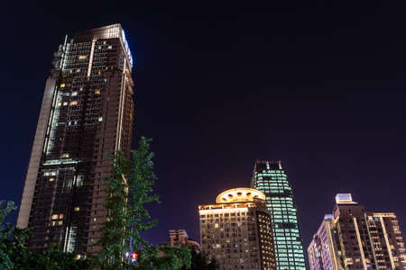 Chongqing, China - August 2019 : Illuminated modern commercial and business buildings in the Jiefangbei district in the downtown of Chongqing city at nightのeditorial素材
