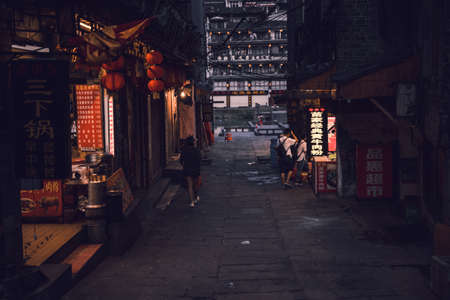 Feng Huang, China -  August 2019 : Few people walking on the dark streets of Fenghuang Old Town, Hunan Provinceのeditorial素材