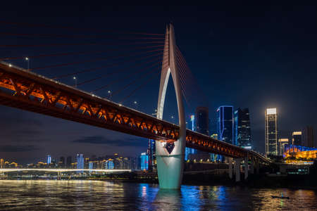 Chongqing, China -  August 2019 : Illuminated DongShuiMen road bridge over and across mighty Yangtze river in Chongqing town at duskのeditorial素材