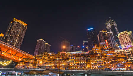 Chongqing, China -  August 2019 : Nightscape of brightly lit stunning Hongyadong Ancient Town