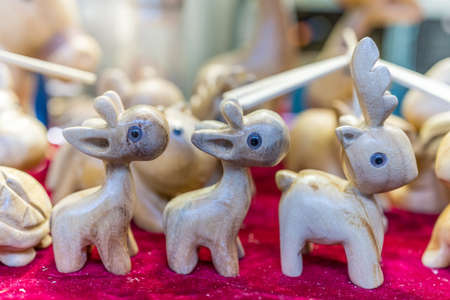 A selective focus of wooden reindeer sculptures displayed in a souvenir shop in Ci Qi Kou Old town, Chongqing, Chinaの写真素材