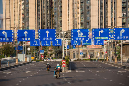 Chongqing, China -  August 2019 :  Wide and almost empty highway road lanes leading to high residential blocks in Chongqing city suburbのeditorial素材