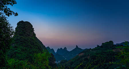 Xianggong Hill viewpoint view of beautiful green, lush and dense karst mountain landscape at dusk, Yangshuo, Guangxi Province, Chinaの写真素材