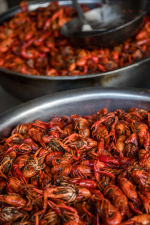 Cooked and fried red spicy chili prawns served in a small street food stall in Feng Huang, Chinaの写真素材