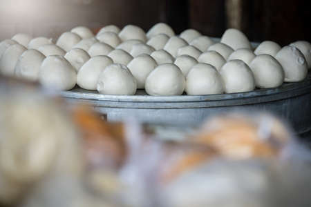 Delicious traditional chinese Baozi buns filled with ground pork meat and cabbage ready to be steamed, Chinaの写真素材