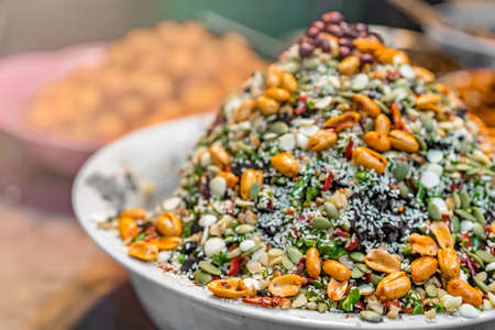 Closeup shot of delicious dessert meal of muesli with  oats, grains, nuts and seeds in a white bowlの写真素材