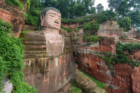 Leshan, China - July 2019 : The close up of the head and torso of the Giant Leshan Buddha, a 71-meter tall stone statue built between 713 and 803 during the Tang Dynasty. Located at the confluence of the Minjiang, Dadu and Qingyi rivers in the southern paのeditorial素材