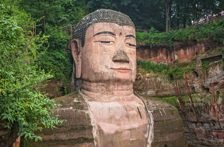 Leshan, China - July 2019 : The close up of the head and torso of the Giant Leshan Buddha, a 71-meter tall stone statue built between 713 and 803 during the Tang Dynasty. Located at the confluence of the Minjiang, Dadu and Qingyi rivers in the southern paのeditorial素材