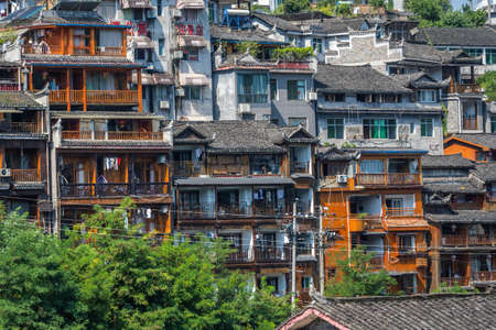 Feng Huang, China -  August 2019 : Facades of row of old historic wooden Diaojiao houses on the riverbanks of Tuo riverのeditorial素材