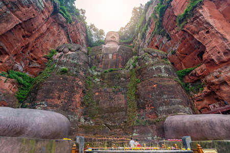 Leshan, China - July 2019 : Memorial candles lit at the bottom of The Giant Leshan Buddha, a 71-meter tall stone statue built between 713 and 803 during the Tang Dynasty. Sichuan provinceのeditorial素材