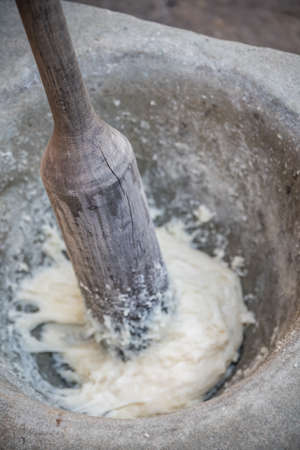 Hard tough wooden stick tool used to hand grinding and mixing flour and egg whites into paste used to making sweet chinese dessert snacks, Chinaの写真素材