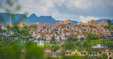Hillside homes, houses and resorts in a town near entrance to the Wulong National Park, Chinaの写真素材