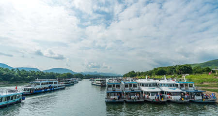 Guilin, China - August 2019 : Sightseeing boats waiting for tourists on the riverbank of the magnificent Li river in Guilinのeditorial素材