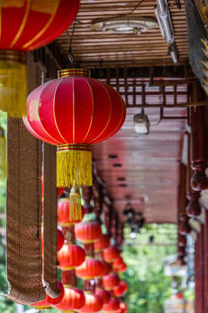Feng Huang, China -  August 2019 : Traditional red Chinese Paper Lanterns hanging from the ceiling of an old historic wooden building in Old Townのeditorial素材