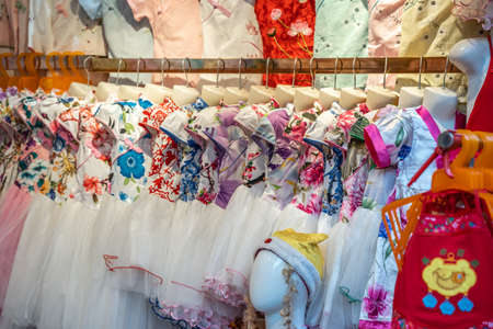 Chongqing, China -  August 2019 : Row of ladies dresses for sale in textile shop in Ci Qi Kou Ancient townのeditorial素材