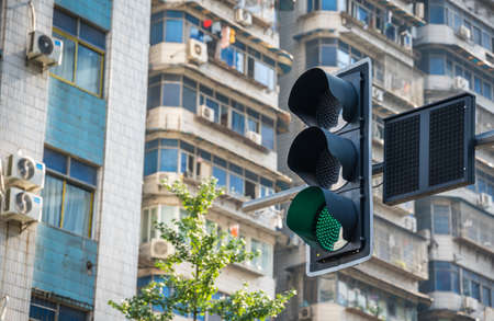 Chongqing, China -  August 2019 : Green traffic light above busy crossroad in city centreのeditorial素材