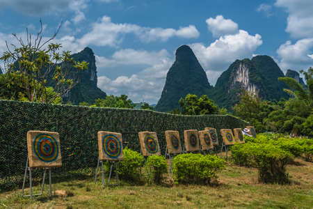 Yangshuo, China - August 2019 : Bow arrow shooting target practice in Shili Scenery Gallery in Yangshuo countryside, Guangxi Provinceのeditorial素材