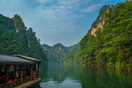 Wullingyuan, China - August 2019 : Tourist boat sailing among stunningly beautiful karst landscape surrounding the Baofeng Lake, Zhangjiajie National Forest Park, Hunan Provinceのeditorial素材