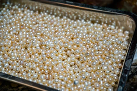 A closeup shot of bright golden colored beads pileの写真素材