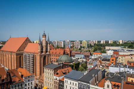Torun, Poland - August 2020 : The Church of the NMP  Najswietszej Maryi Panny  surrounded by buildings under the sunlight and a blue sky in Torun Old townのeditorial素材