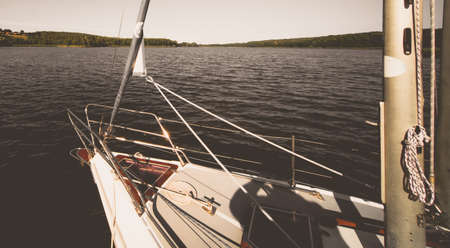Front of a small private leisure boat on the shore of a lake in summerの写真素材