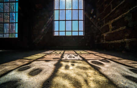 Colorful patterns of a light coming through the frosted stained window in an old clock towerの写真素材