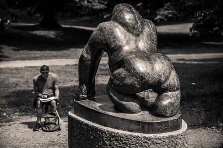 London, UK - June 2020 : Artists sitting in front of a marble giant black gorilla statue and making a sketch of it, picture taken in summer in Crystal Palace Parkのeditorial素材