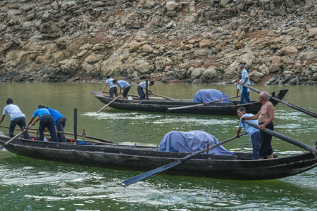 Yangtze River, China - August 2019 : Men catching fish from a small crowded fisherman boats on the...
