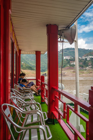 Yangtze River, China - August 2019 : Tourists sitting on the first class observation deck on the luxury passenger cruise ship sailing through the gorge on the magnificent Yangtze Riverのeditorial素材