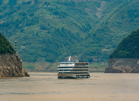 Yangtze River, China - August 2019 : Luxury passenger cruise ship sailing through the gorge on the magnificent Yangtze Riverのeditorial素材