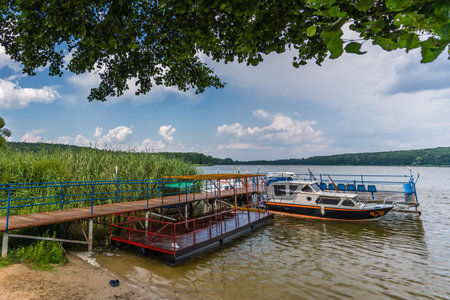 Jezioro Ostrowieckie, Poland - July 2020 : Private Boat landing and pier on a boat on Jezioro Ostrowieckieのeditorial素材