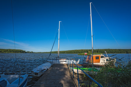 Jezioro Ostrowieckie, Poland - July 2020 : Private Boat landing and pier on a boat on Jezioro Ostrowieckieのeditorial素材