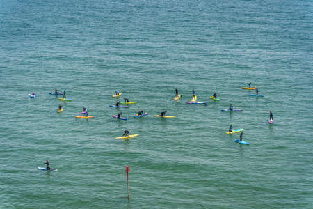 Tenby, Wales - May 2021 : Swimmers Paddle boarding on a hot day in Tenby coast , Carmarthen Bay, Pembrokeshireのeditorial素材