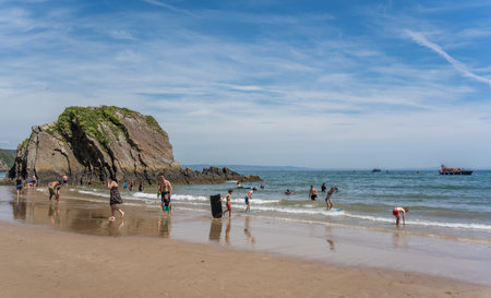 Tenby, Wales - May 2021 : People enjoying sunshine hot day on the historic Tenby town beach and coast, Carmarthen Bay, Pembrokeshireのeditorial素材